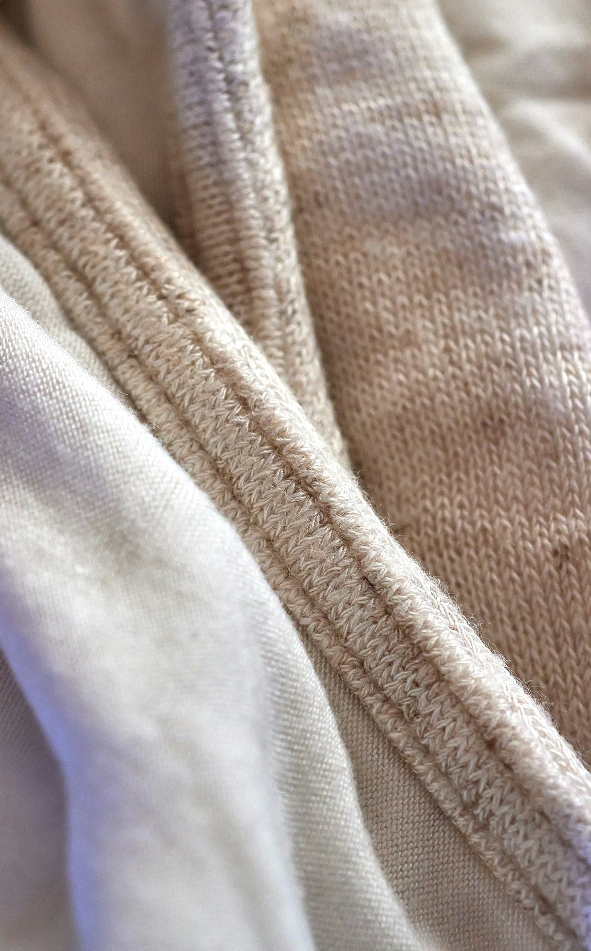 Close-up view of neutral woven fabrics and stitching details