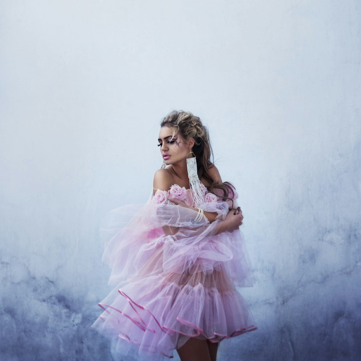 Woman wearing an expressive pink fashion dress with floral detailing, by Marina Nazina